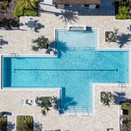 a building with a pool and trees