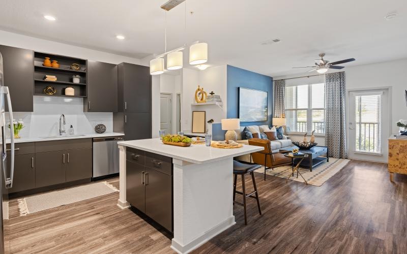 a kitchen with a bar and chairs